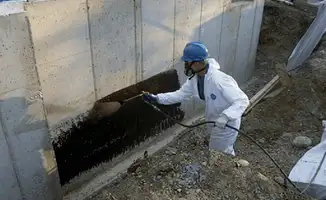 Professional waterproofing the exterior walls of the basement in Mobile, AL