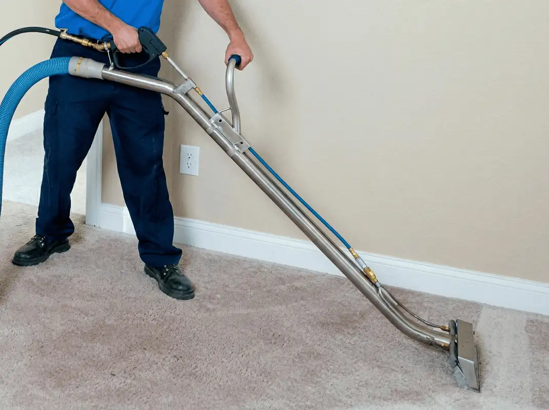 Professional operating a liquid removal machine on a carpeted floor in Mobile, AL